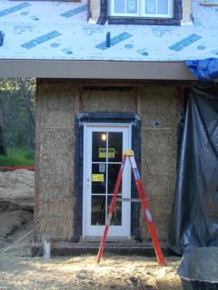 [Exterior straw bale wall before wire mesh]