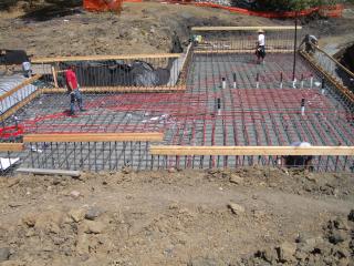 [Basement slab rebar with radiant heat tubes being laid]